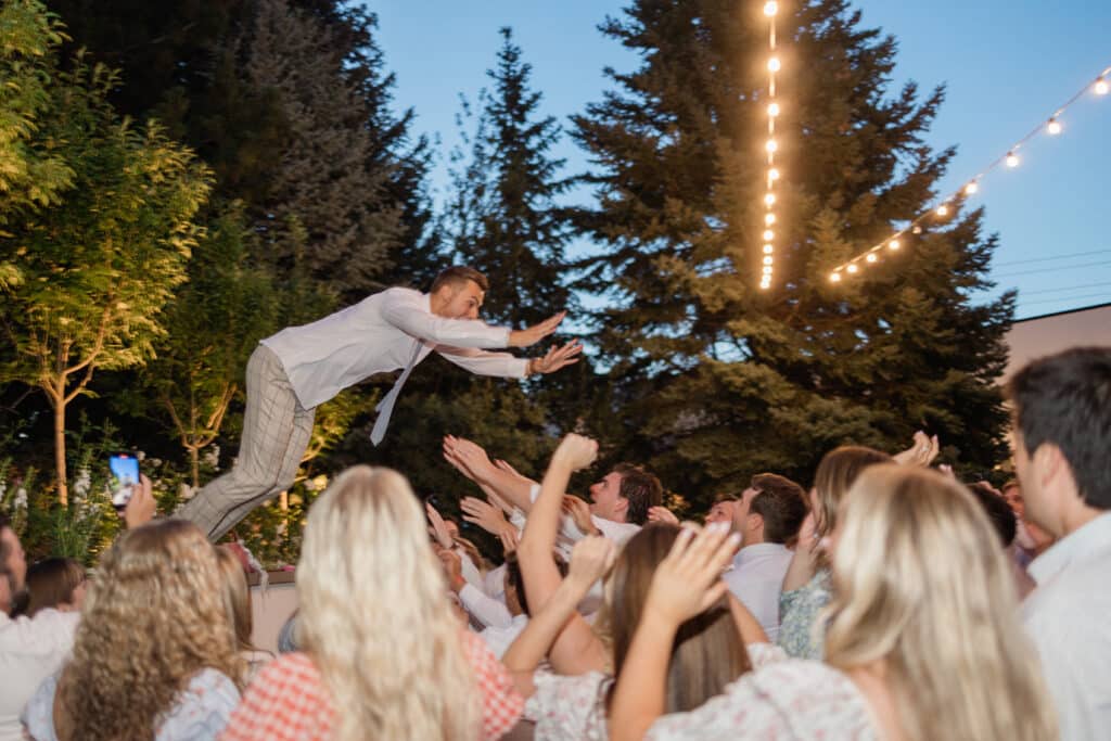 Wedding Reception at Twenty and Creek Groom Jumping into the crowd on the dance floor