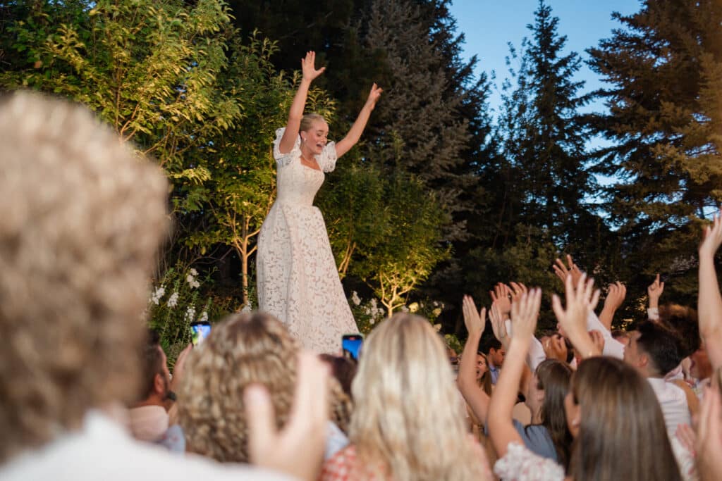 Wedding Reception at Twenty and Creek Bride hyping up the crowd on the wall